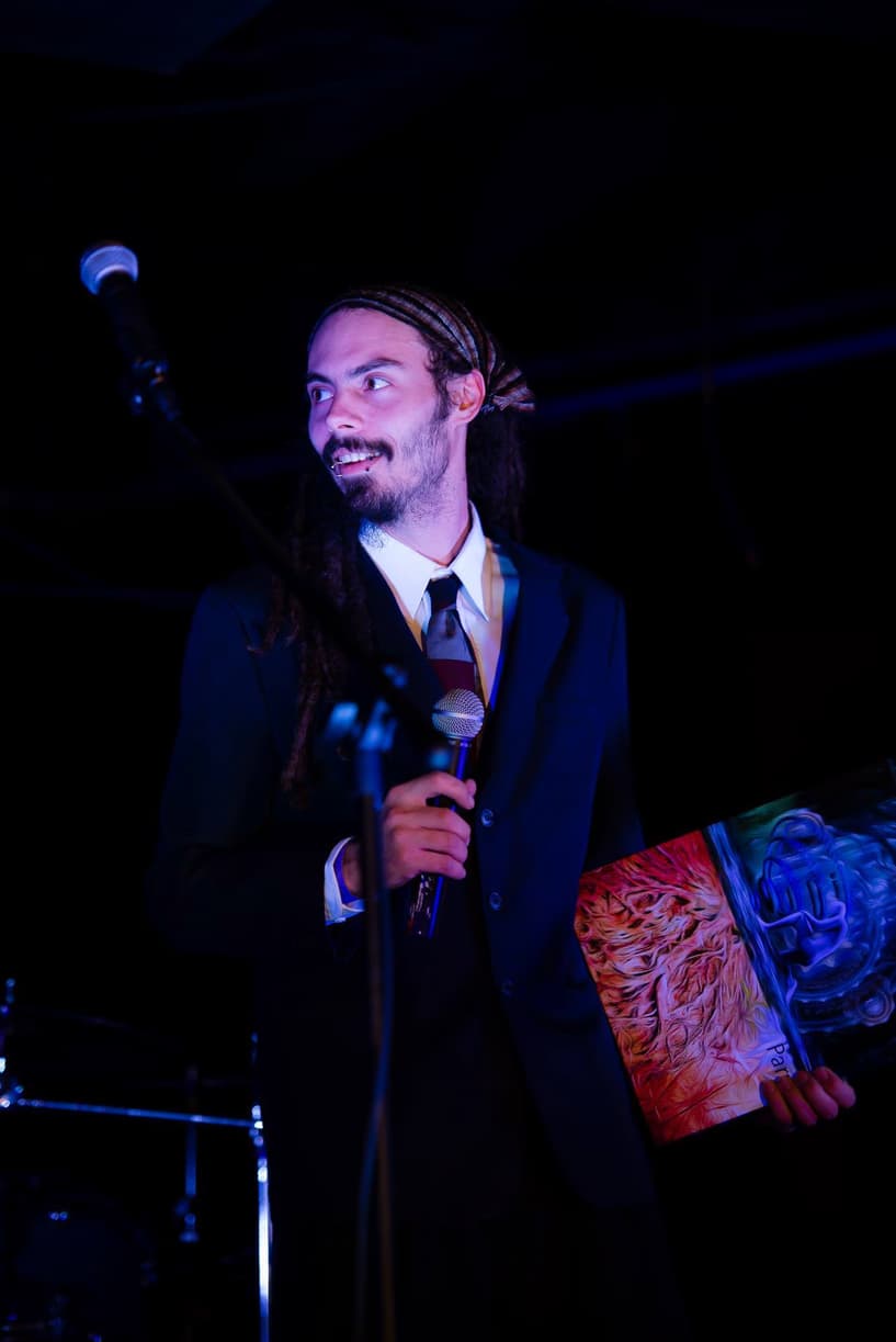 Derek on Stage presenting art prints